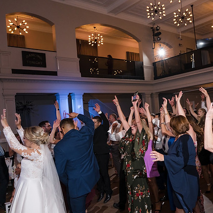a photo of the wedding reception in the reception hall at revel 32 where the guests are dancing and having a great time